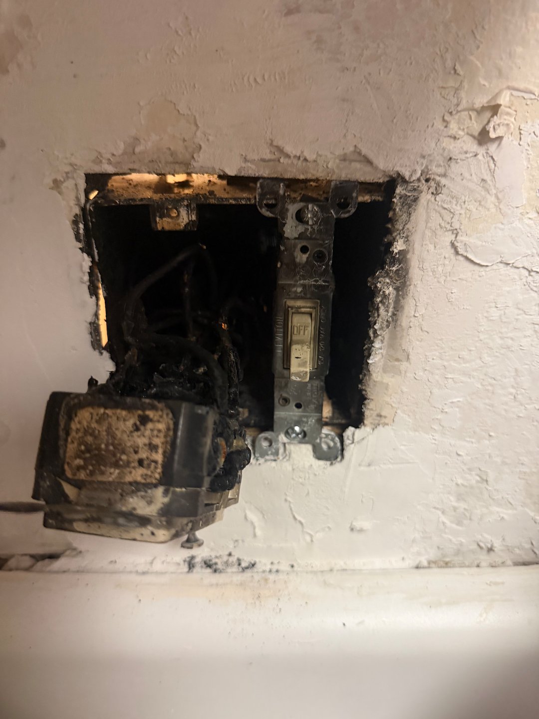 Unsafe Electrical Failure Revealed Behind Wall Plate
